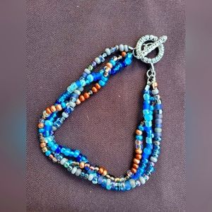 Beaded 3 strand, blue, and gold colors. Bracelet or anklet.